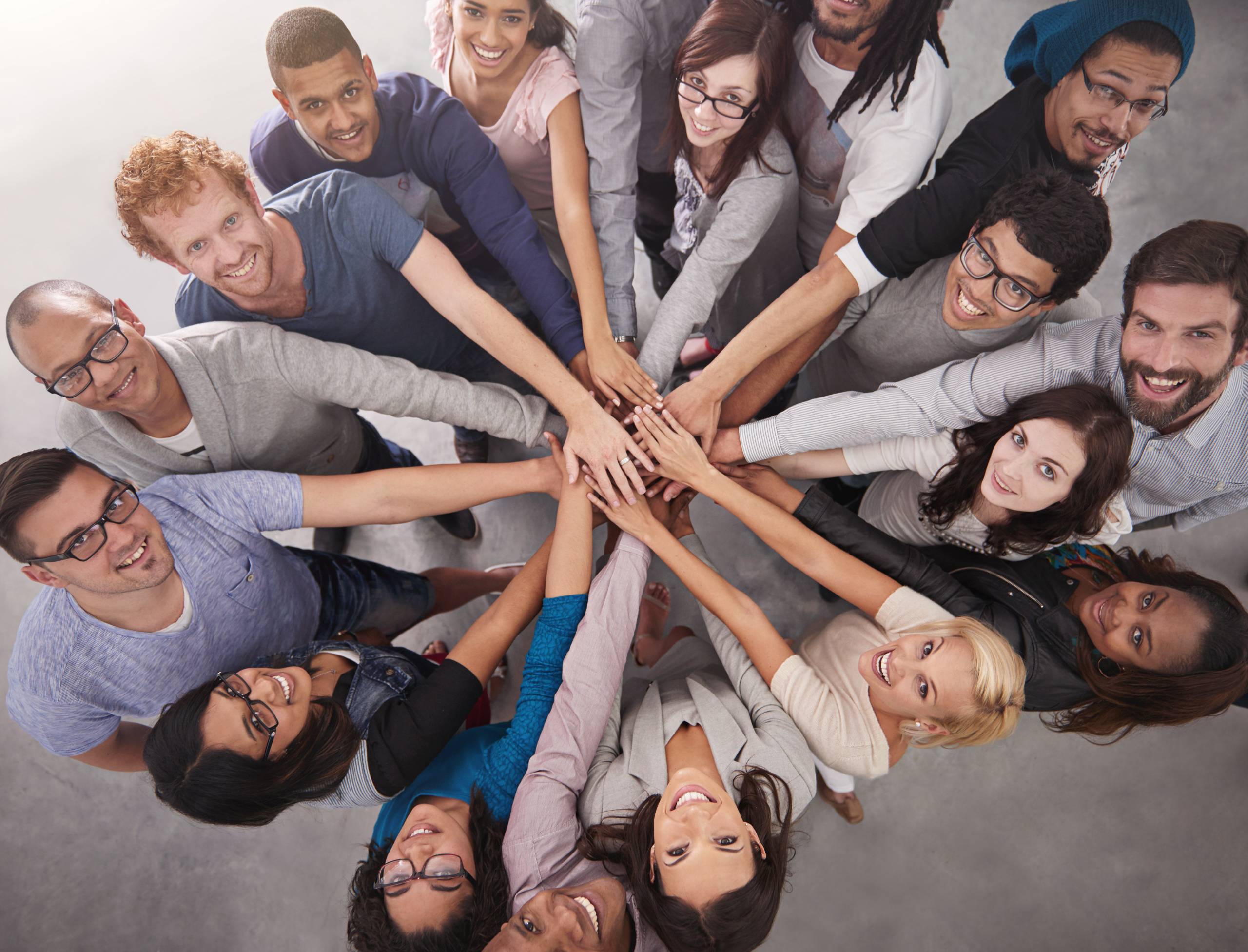 High angle portrait of a business team standing in a circle with their hands stacked.
